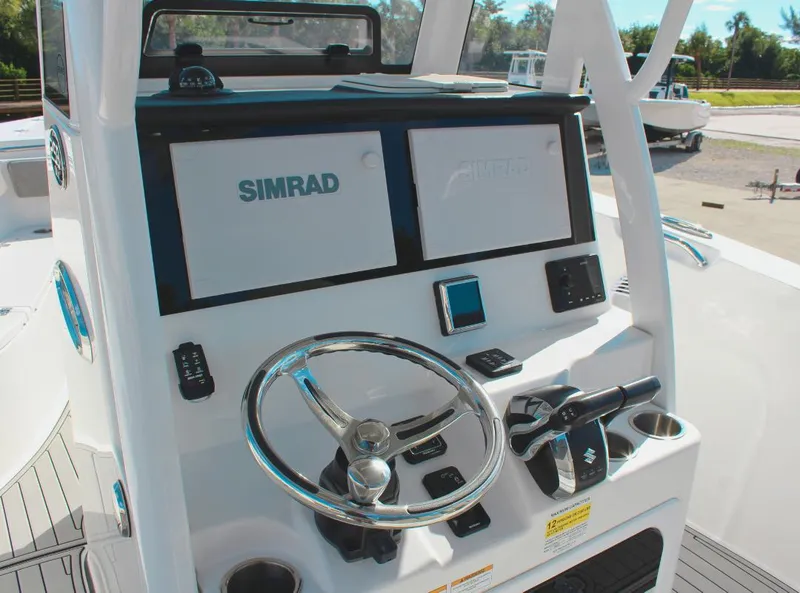 Slide: The Image of 2023 Seapro 259 boat dashboard with Simrad navigation system and steering wheel. - 13
