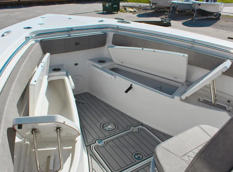 Slide: The Image of 2023 Seapro 259 boat interior with open storage compartments and cushioned seating. - 18