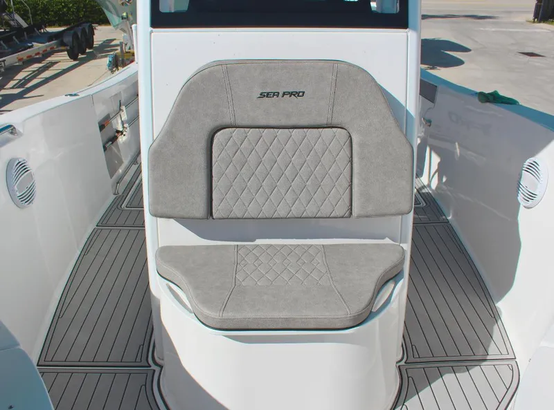 Slide: The Image of 2023 Seapro 259 boat seat with gray cushioned upholstery and diamond pattern. - 19