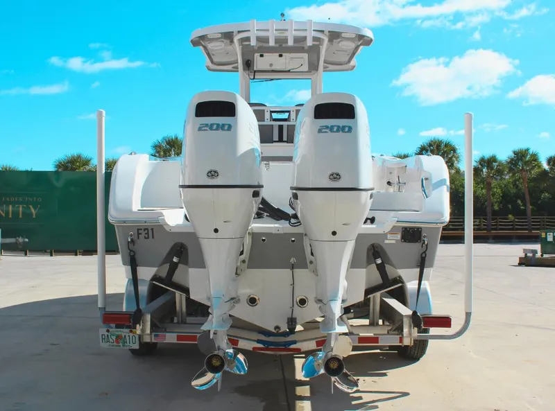 Slide: The Image of 2023 Seapro 259 boat with dual 200 horsepower engines on a trailer. - 2