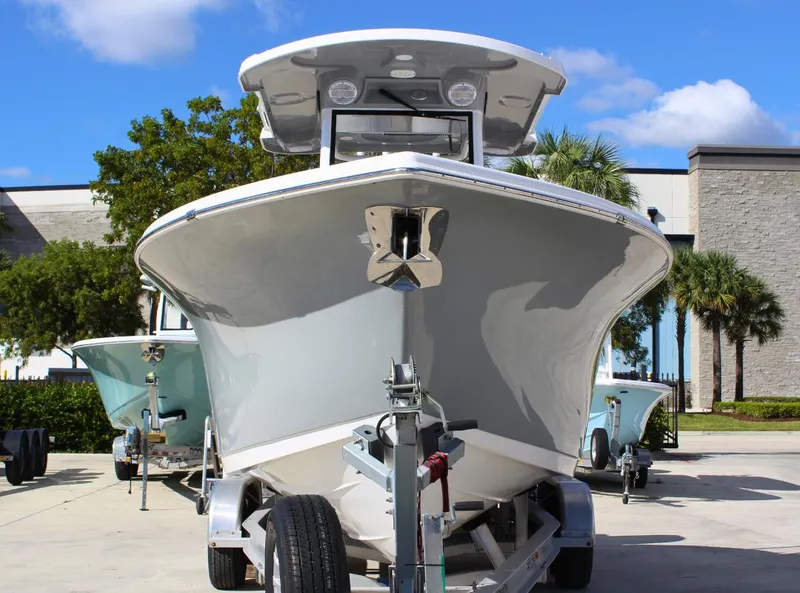Slide: The Image of 2023 Seapro 259 boat on trailer, parked outdoors under blue sky. - 3