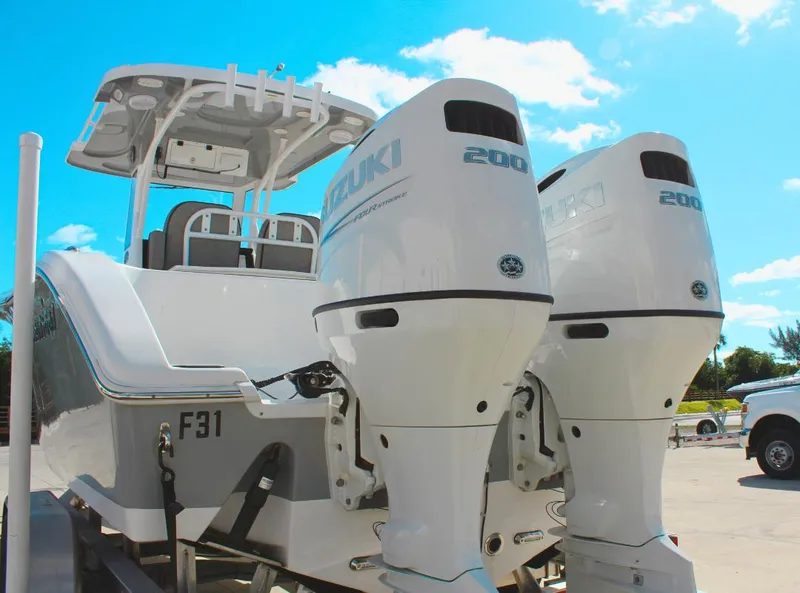 Slide: The Image of 2023 Seapro 259 boat with dual Suzuki 200 outboard engines, parked outdoors. - 5