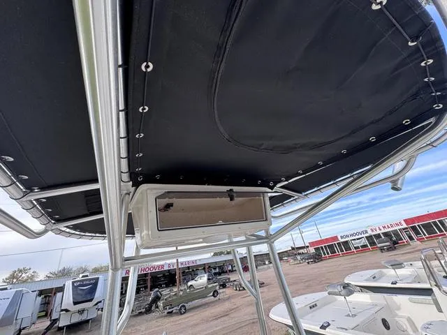 Slide: The Image of 2025 Carolina Skiff 22 Ultra Elite boat with T-top and storage compartment. - 15