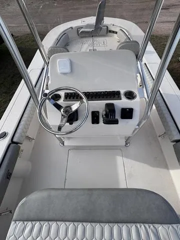 Slide: The Image of 2025 Carolina Skiff 22 Ultra Elite boat console with steering wheel and seating. - 16