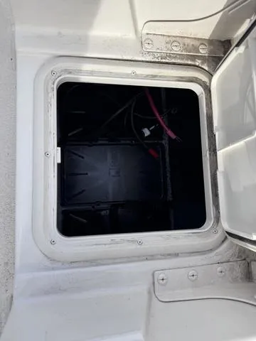 Slide: The Image of 2025 Carolina Skiff 22 Ultra Elite battery compartment with wiring visible. - 19