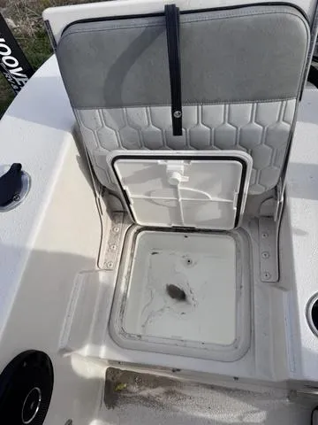 Slide: The Image of 2025 Carolina Skiff 22 Ultra Elite boat seat with storage compartment open. - 21