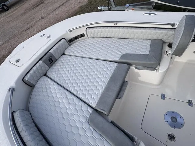 Slide: The Image of 2025 Carolina Skiff 22 Ultra Elite boat with cushioned seating and sleek design. - 7