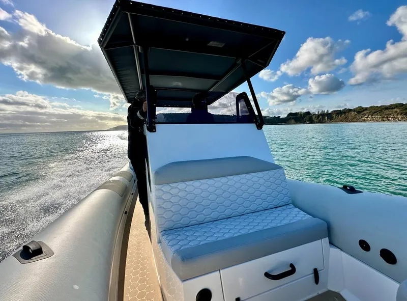 Slide: The Image of Arksen 8 boat cruising on clear water under a sunny sky, 2025 model. - 3