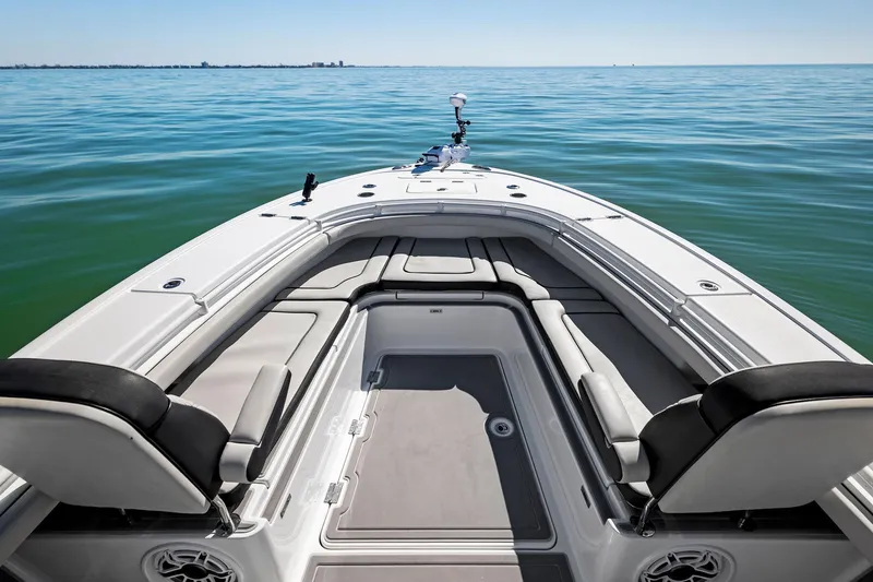 Slide: The Image of 2021 Barker Boatworks 26 Open on calm sea, showcasing spacious deck and seating. - 10