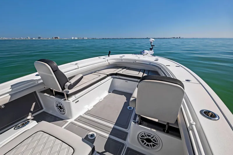 Slide: The Image of 2021 Barker Boatworks 26 Open on calm sea, showcasing spacious deck and seating. - 11