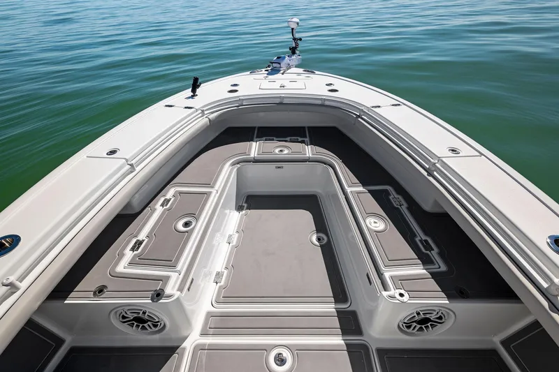 Slide: The Image of 2021 Barker Boatworks 26 Open deck, featuring spacious storage and sleek design on calm waters. - 12