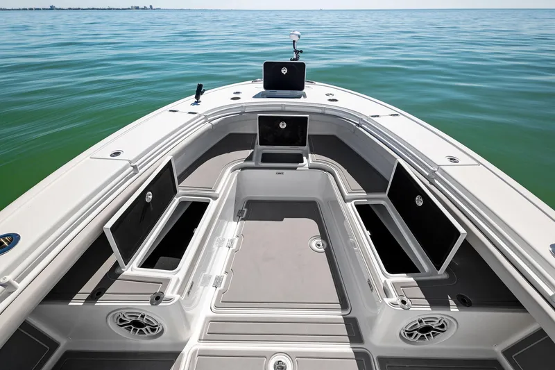 Slide: The Image of 2021 Barker Boatworks 26 Open on calm water, showcasing spacious deck and storage compartments. - 13