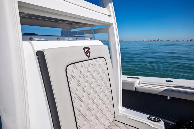Slide: The Image of 2021 Barker Boatworks 26 Open, luxury seating detail, ocean backdrop. - 15