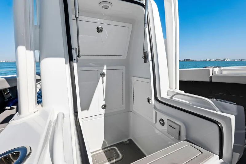 Slide: The Image of 2021 Barker Boatworks 26 Open interior storage compartments on a sunny day. - 16