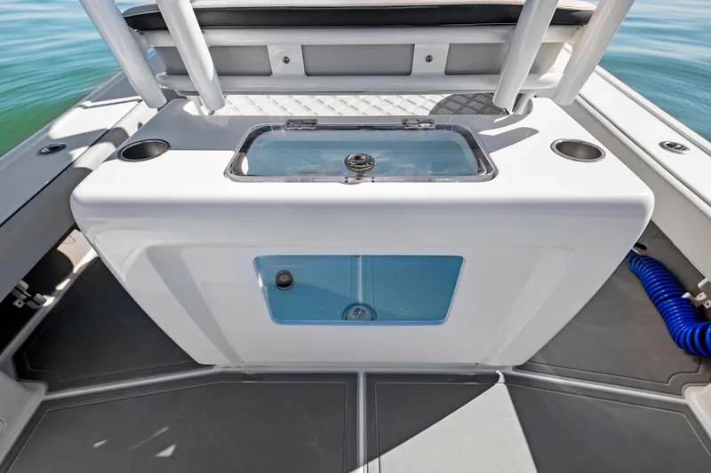 Slide: The Image of Barker Boatworks 26 Open 2021, center console with storage and cup holders on deck. - 23