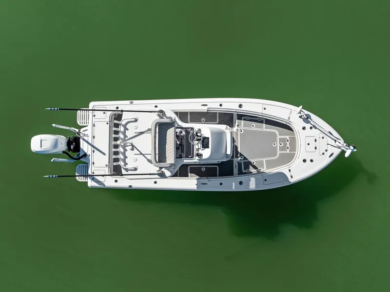 Slide: The Image of Aerial view of 2021 Barker Boatworks 26 Open on green water. - 4