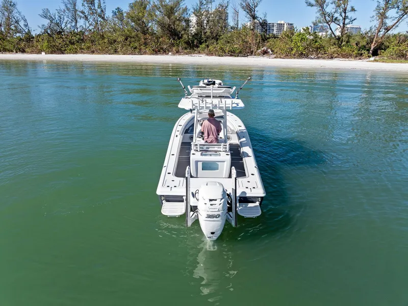 Slide: The Image of 2021 Barker Boatworks 26 Open on calm water near a sandy shoreline. - 5