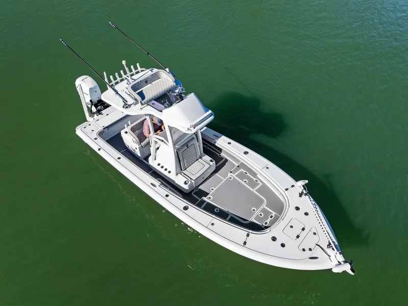 Slide: The Image of Aerial view of 2021 Barker Boatworks 26 Open on calm green water. - 6