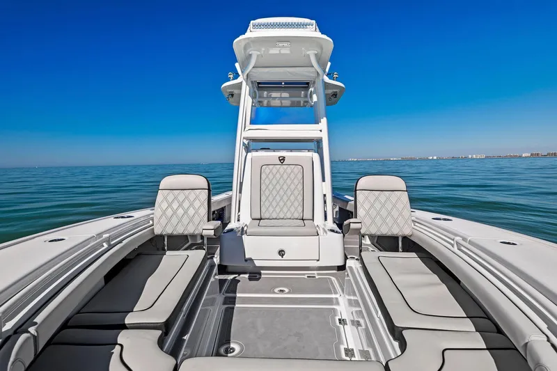 Slide: The Image of 2021 Barker Boatworks 26 Open on calm ocean, showcasing spacious deck and seating. - 8