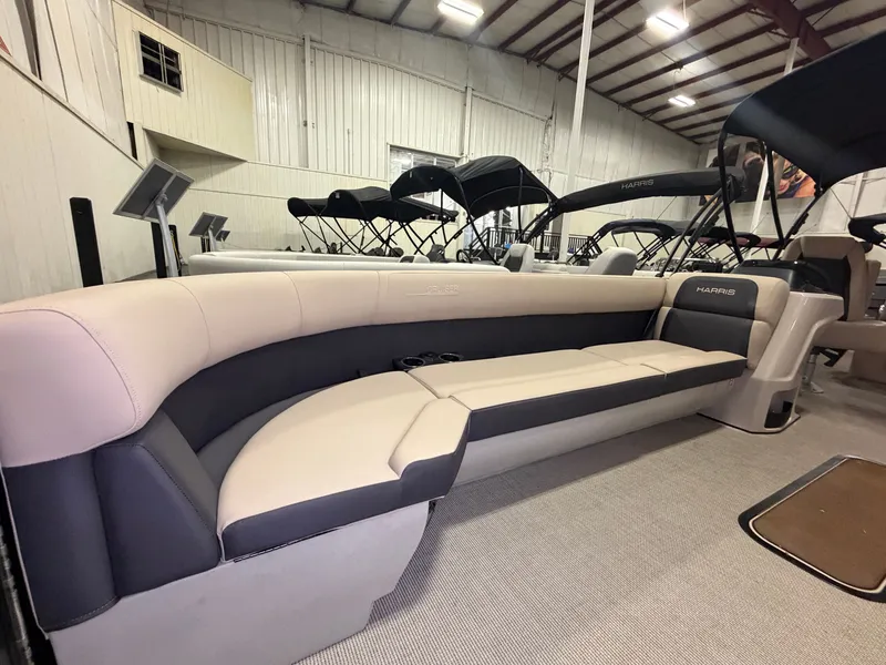Slide: The Image of Interior of the 2025 Harris Cruiser 250 with sleek upholstery and spacious seating area. - 1