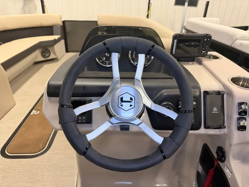 Slide: The Image of The image shows the helm of a 2025 Harris Cruiser 250 with modern instruments. - 18