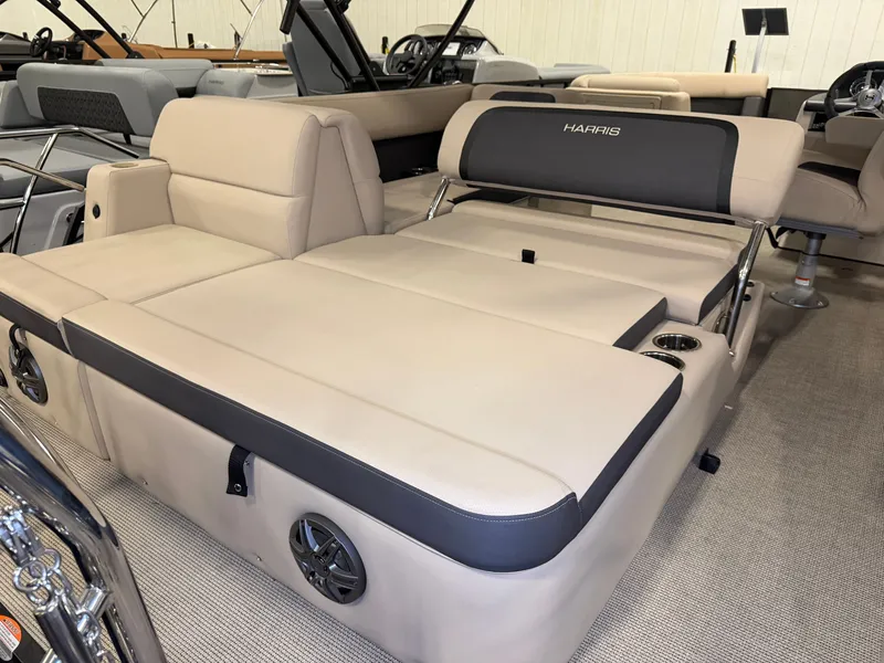Slide: The Image of The image shows the beige interior of a 2025 Harris Cruiser 250 with cushioned seating. - 30