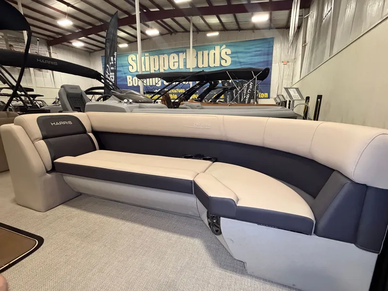 Slide: The Image of Interior of a 2025 Harris Cruiser 250 with beige and gray upholstery in a warehouse setting. - 7