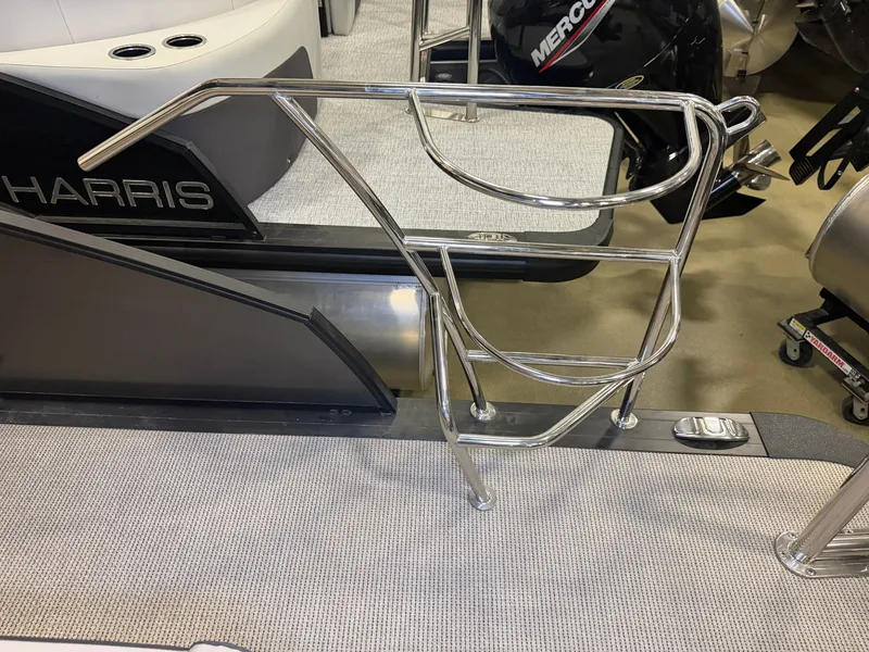 Slide: The Image of A shiny metal handrail on a boat, with an engine in the background. - 34