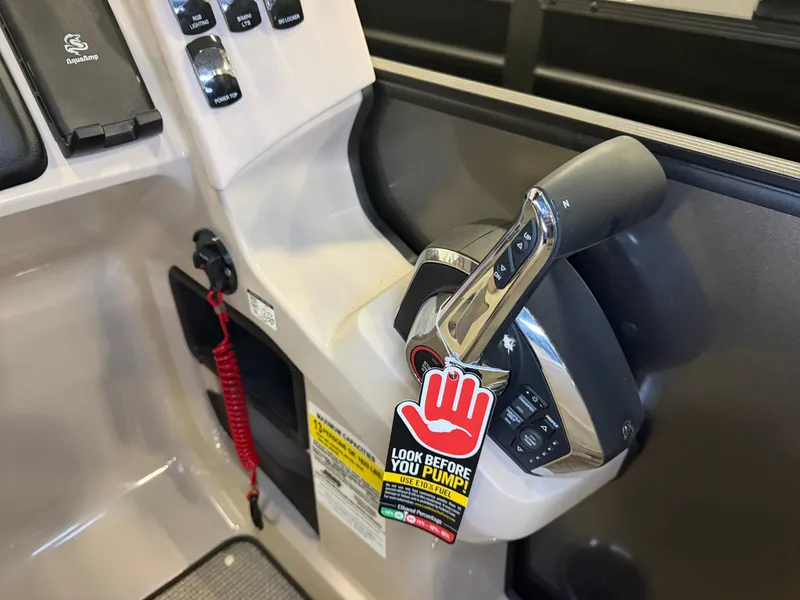 Slide: The Image of Close-up of the throttle lever on a 2025 Harris Cruiser 250 with a warning tag. - 19