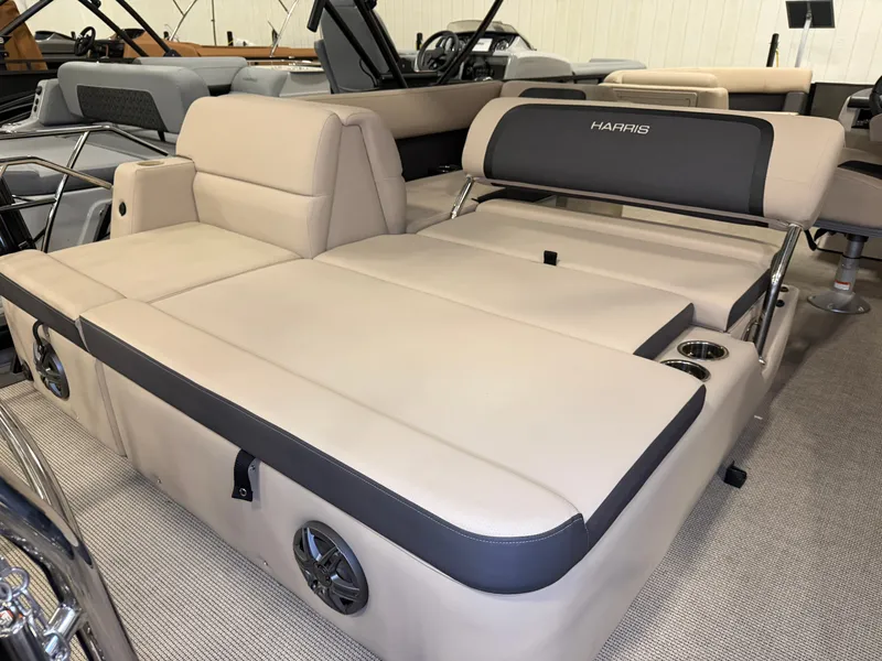 Slide: The Image of The image shows the beige and black seating area of a 2025 Harris Cruiser 250. - 31