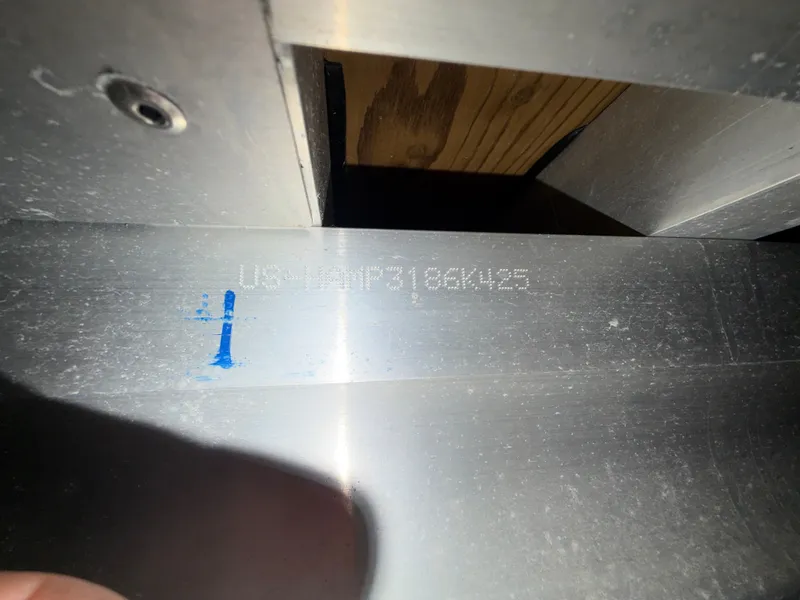 Slide: The Image of Close-up of a metal surface with an engraved serial number. - 43