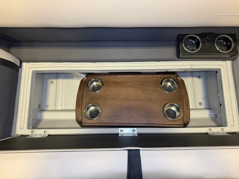 Slide: The Image of A table with cup holders in a boat, surrounded by cushioned seating and controls. - 9