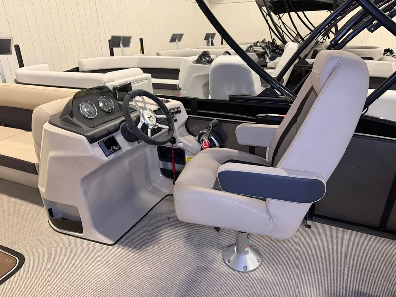 Slide: The Image of The image shows the cockpit of a 2025 Harris Cruiser 250 with a beige captain's chair. - 12