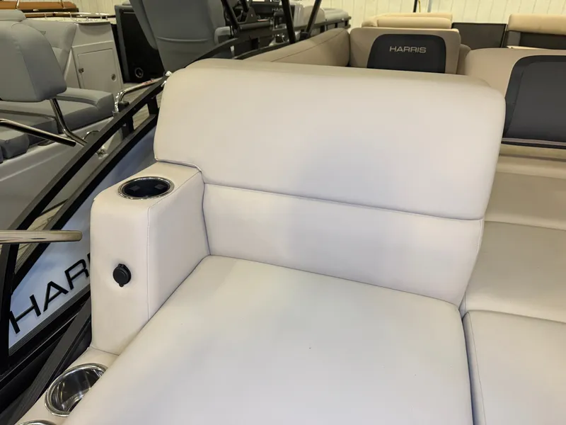 Slide: The Image of The 2025 Harris Cruiser 250 features luxurious cream-colored upholstery with built-in cup holders. - 39