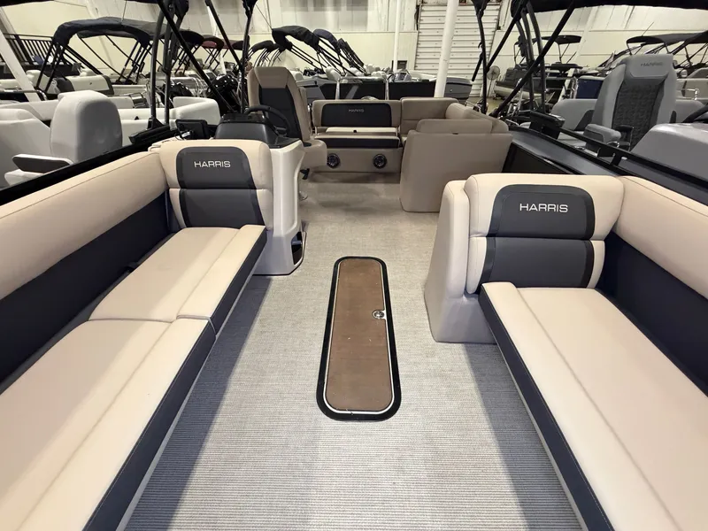Slide: The Image of Interior of a Harris Cruiser 250 pontoon boat with beige and gray seating. - 10