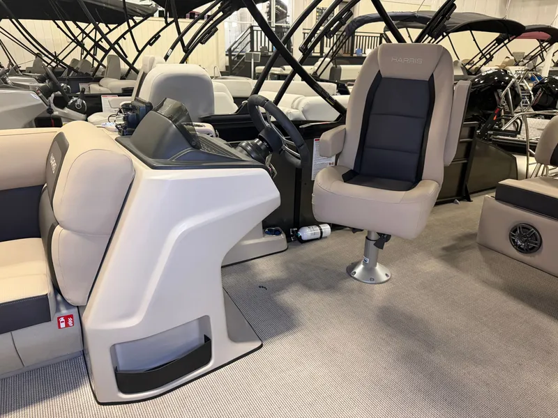 Slide: The Image of Interior of a 2025 Harris Cruiser 250 with beige and gray upholstery and a modern helm station. - 11