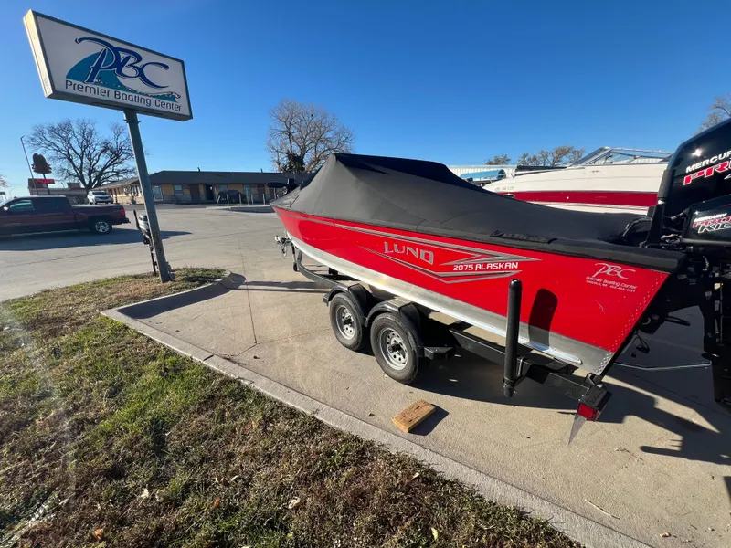 Slide: The Image of 2024 Lund 2075 Alaskan Sport boat on trailer at Premier Boating Center. - 2