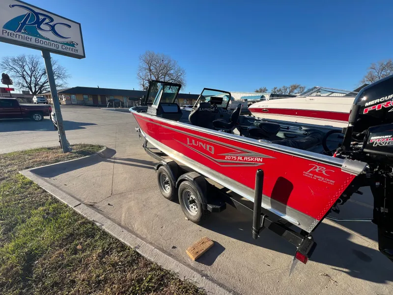 Slide: The Image of 2024 Lund 2075 Alaskan Sport boat in red at Premier Boating Center. - 5