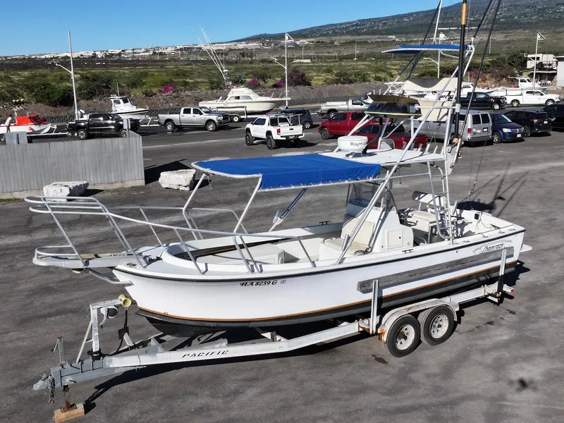 The Image of 1997 Shamrock 260 Open boat on trailer in a marina parking lot. - 1