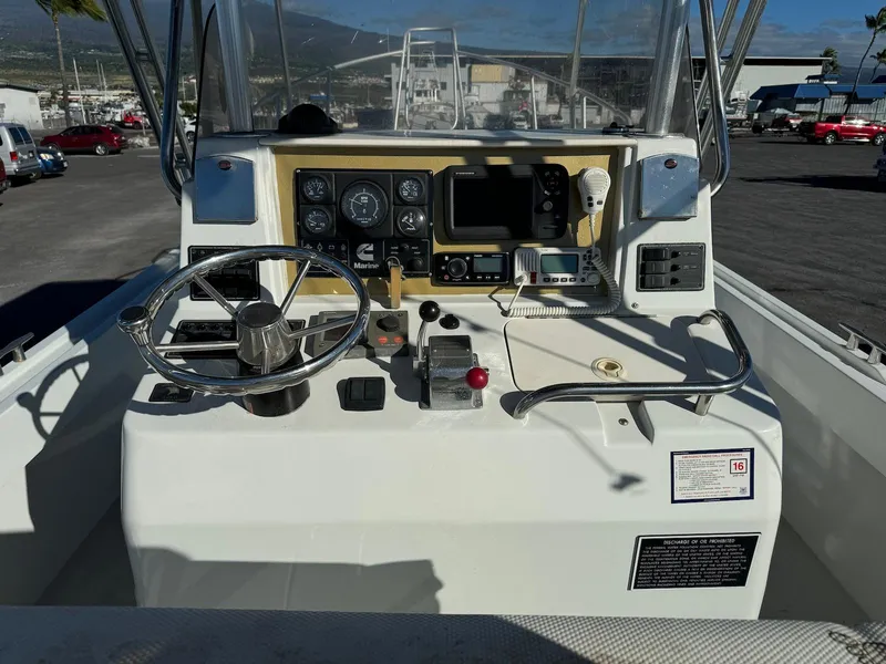 Slide: The Image of 1997 Shamrock 260 Open boat dashboard with steering wheel and navigation instruments. - 14