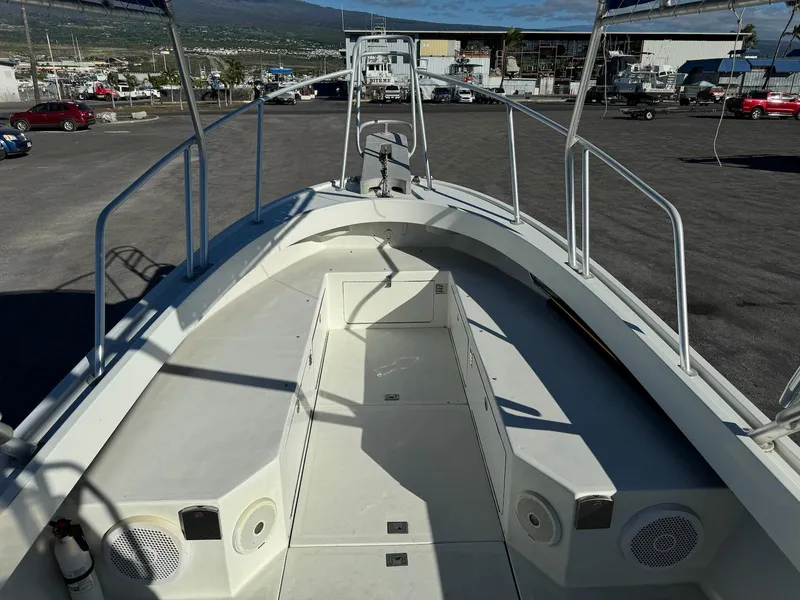 Slide: The Image of 1997 Shamrock 260 Open boat, spacious deck, docked in a marina setting. - 19