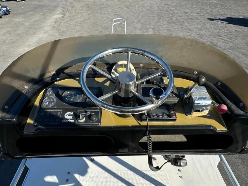 Slide: The Image of 1997 Shamrock 260 Open boat dashboard with steering wheel and control panel. - 24