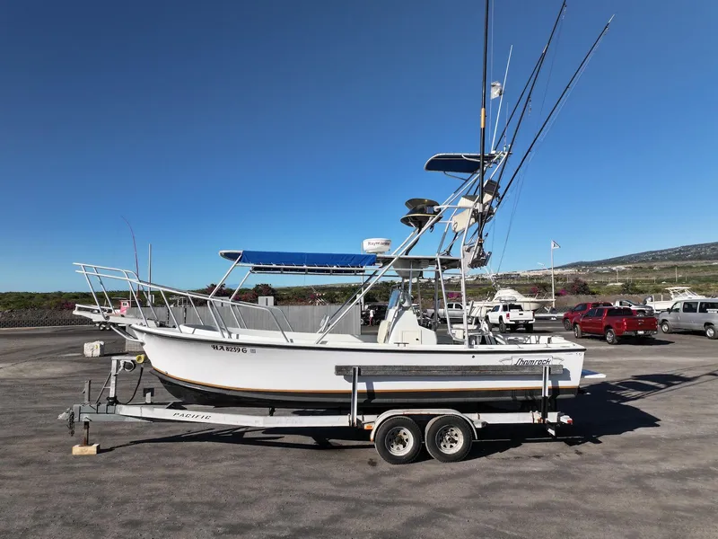 Slide: The Image of 1997 Shamrock 260 Open boat on trailer, parked in a sunny lot. - 3