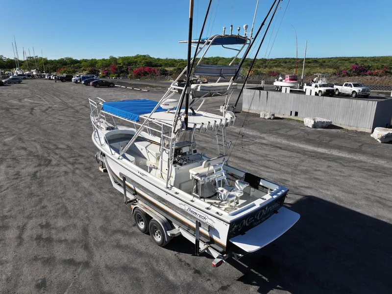 Slide: The Image of 1997 Shamrock 260 Open boat on trailer in parking lot. - 4