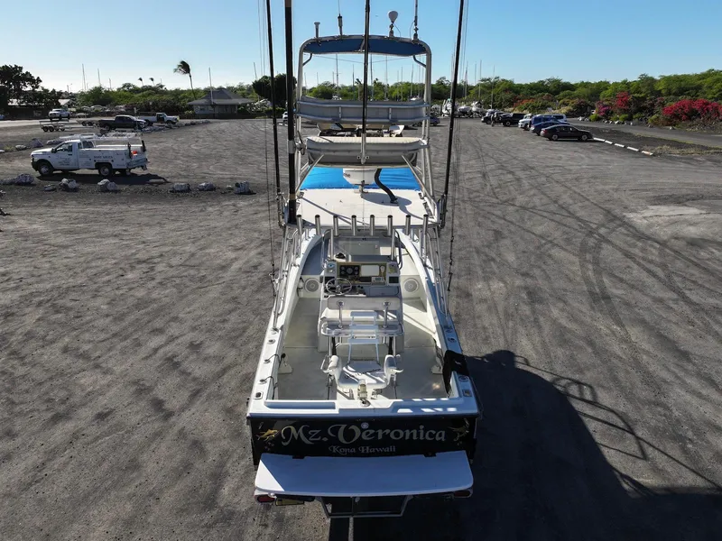 Slide: The Image of 1997 Shamrock 260 Open boat on land, rear view, with fishing equipment. - 5