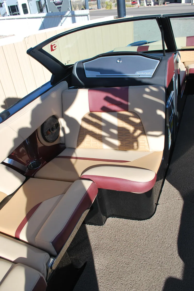 Slide: The Image of 2023 MasterCraft X24 boat interior with beige and maroon seating. - 11