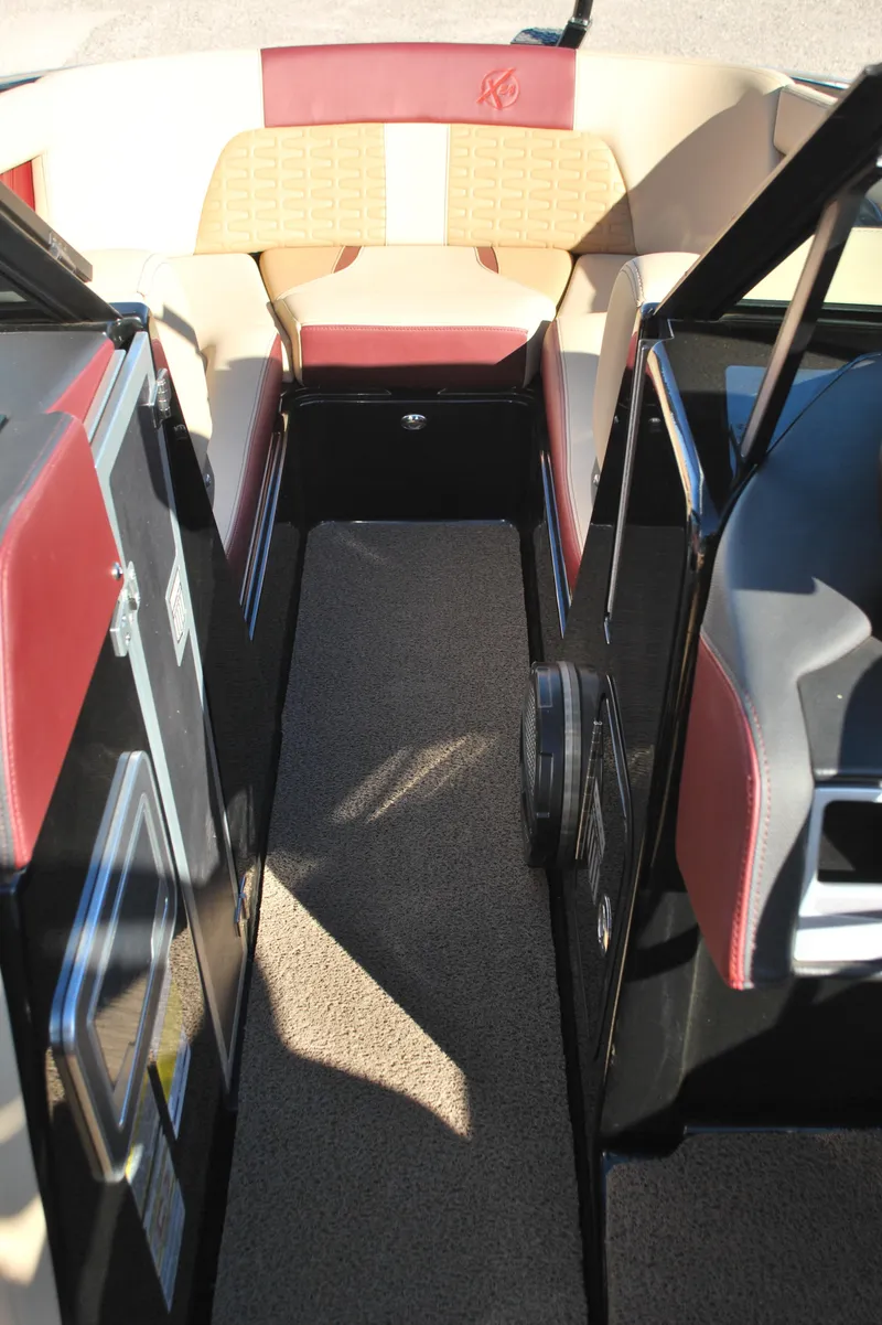 Slide: The Image of 2023 MasterCraft X24 boat interior with red and beige seating. - 12