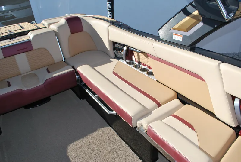 Slide: The Image of 2023 MasterCraft X24 boat interior with beige and maroon seating. - 13