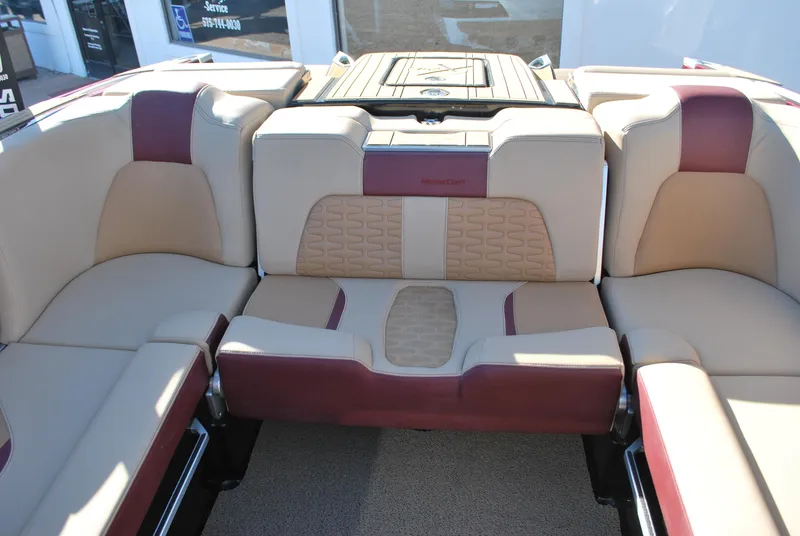 Slide: The Image of 2023 MasterCraft X24 boat interior with beige and maroon seating. - 15