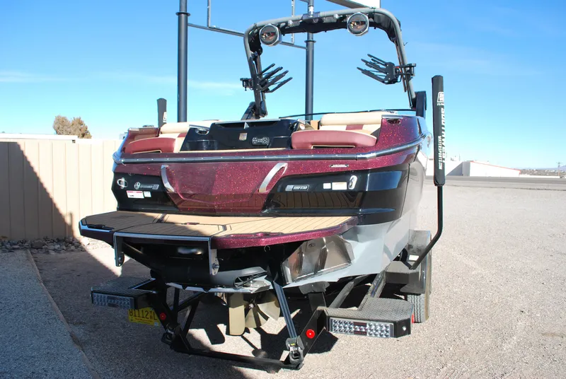 Slide: The Image of 2023 MasterCraft X24 boat, rear view, parked on a trailer. - 20